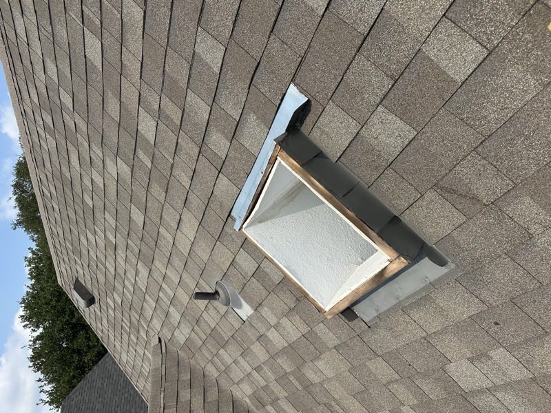 Skylight curb and flashing reset into the shingles