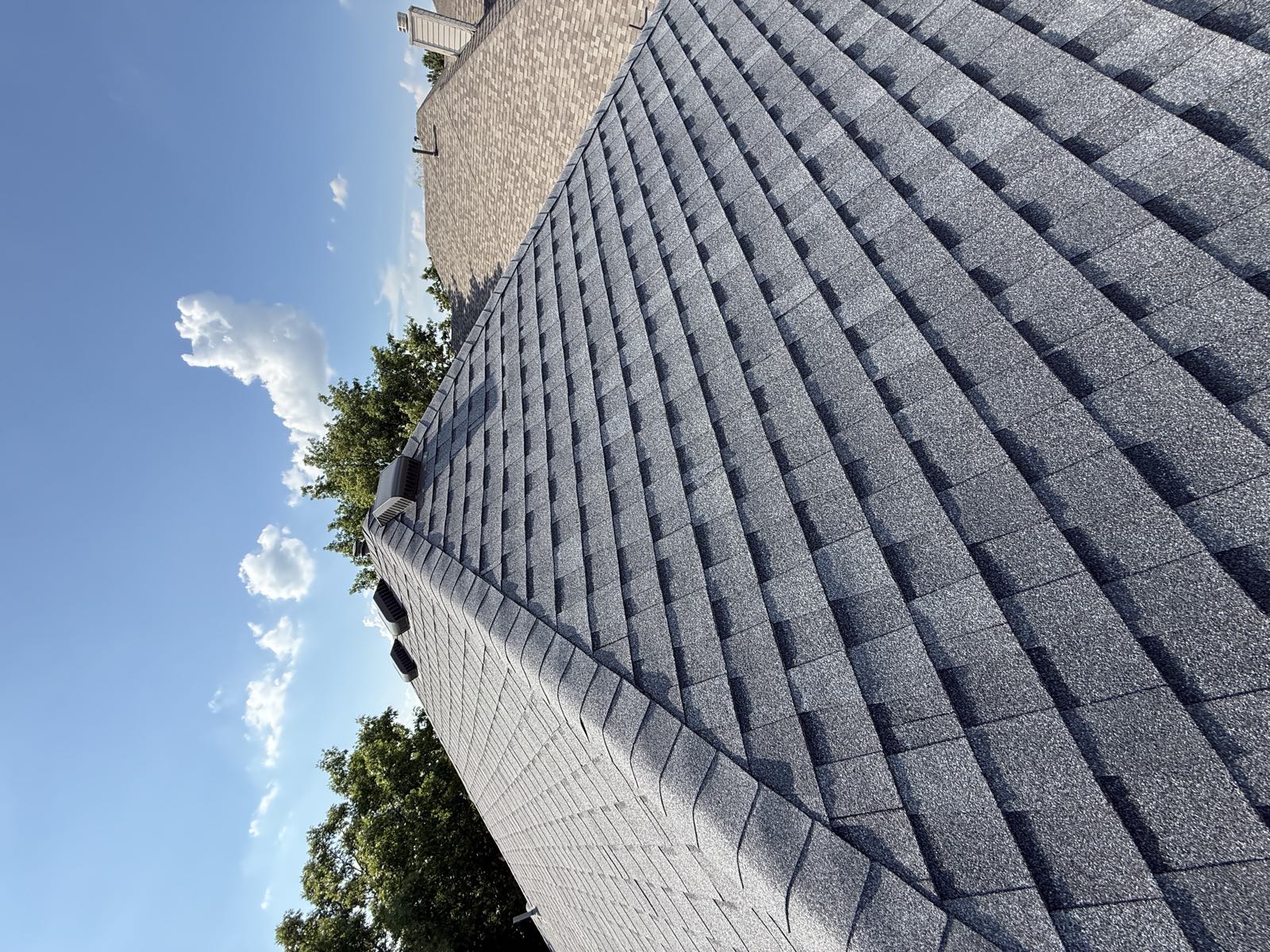 Clean shingle ridge line against open sky