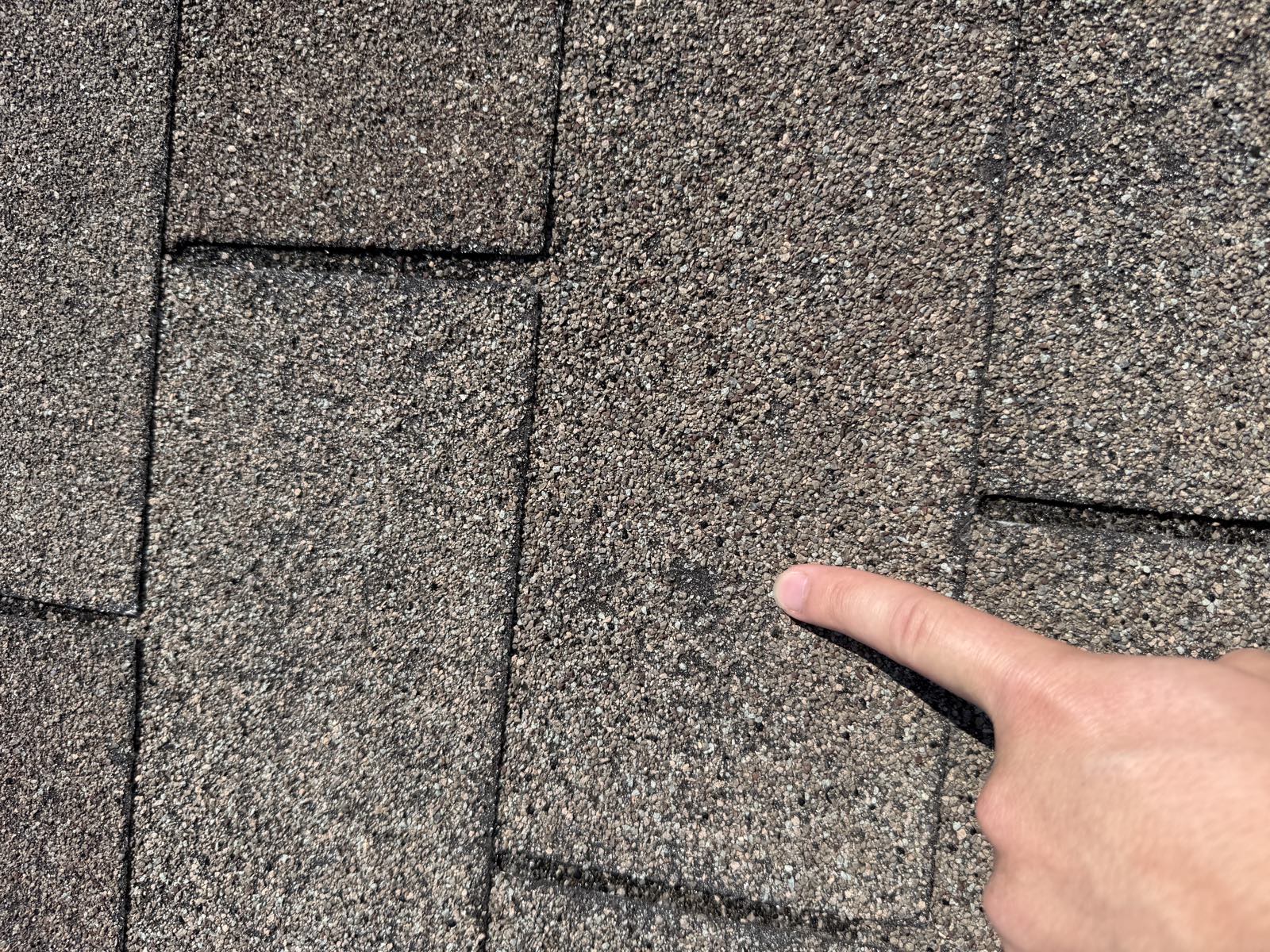 Pointing out a hail impact during an inspection
