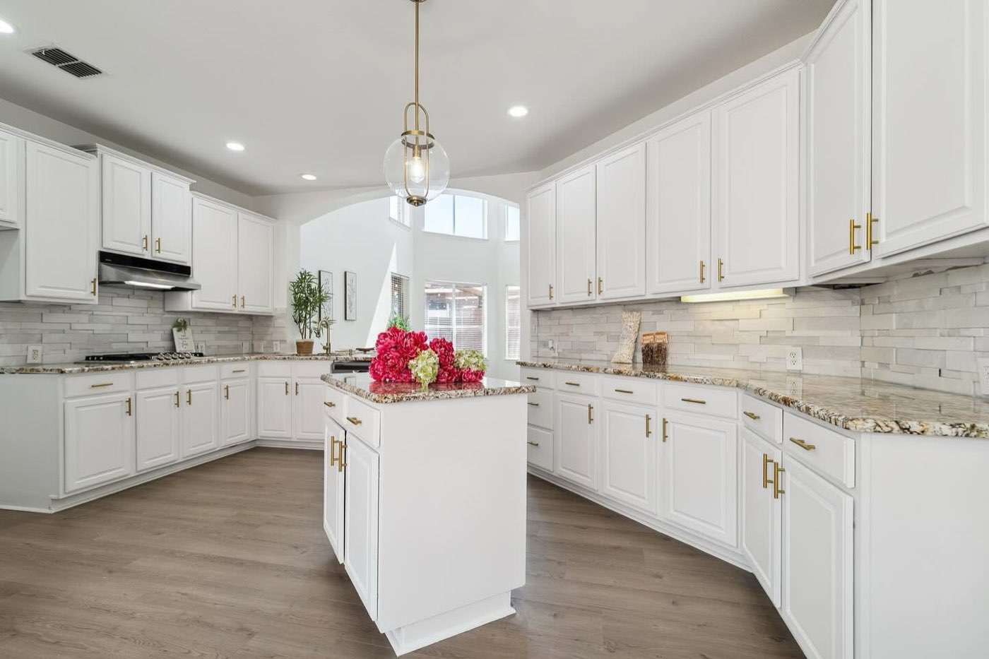 Finished white kitchen with island and quartz counters