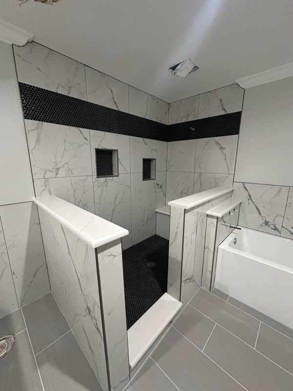 Marble look shower tile going in over framed knee walls