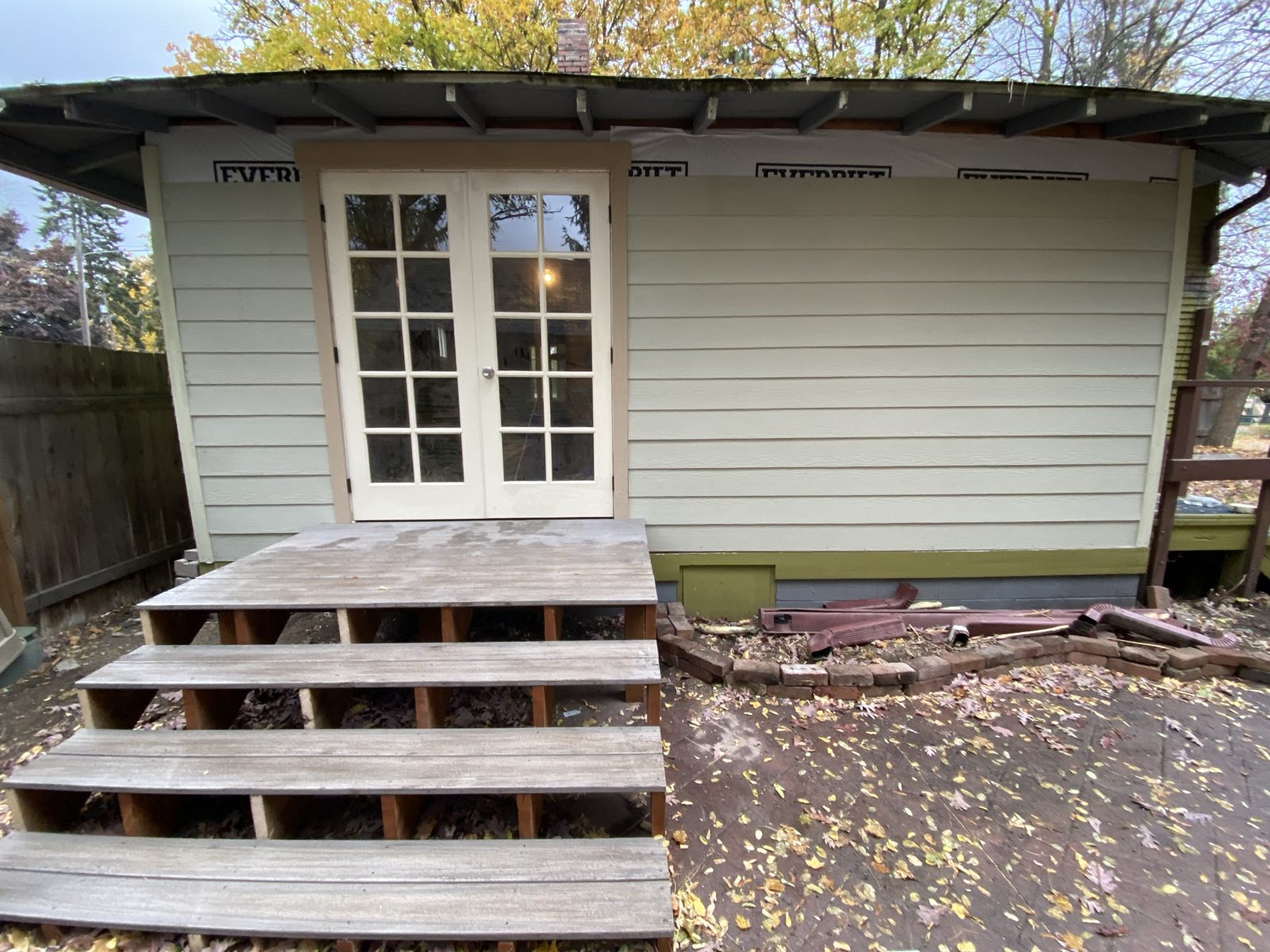 Rear addition with french doors onto a wood deck