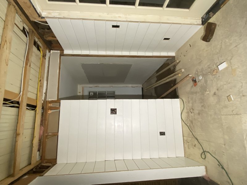 Shiplap going up in a hallway with the ceiling still open