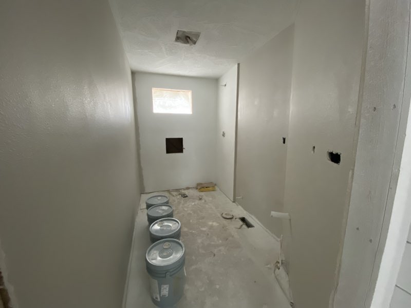 Small room drywalled with paint staged on the floor